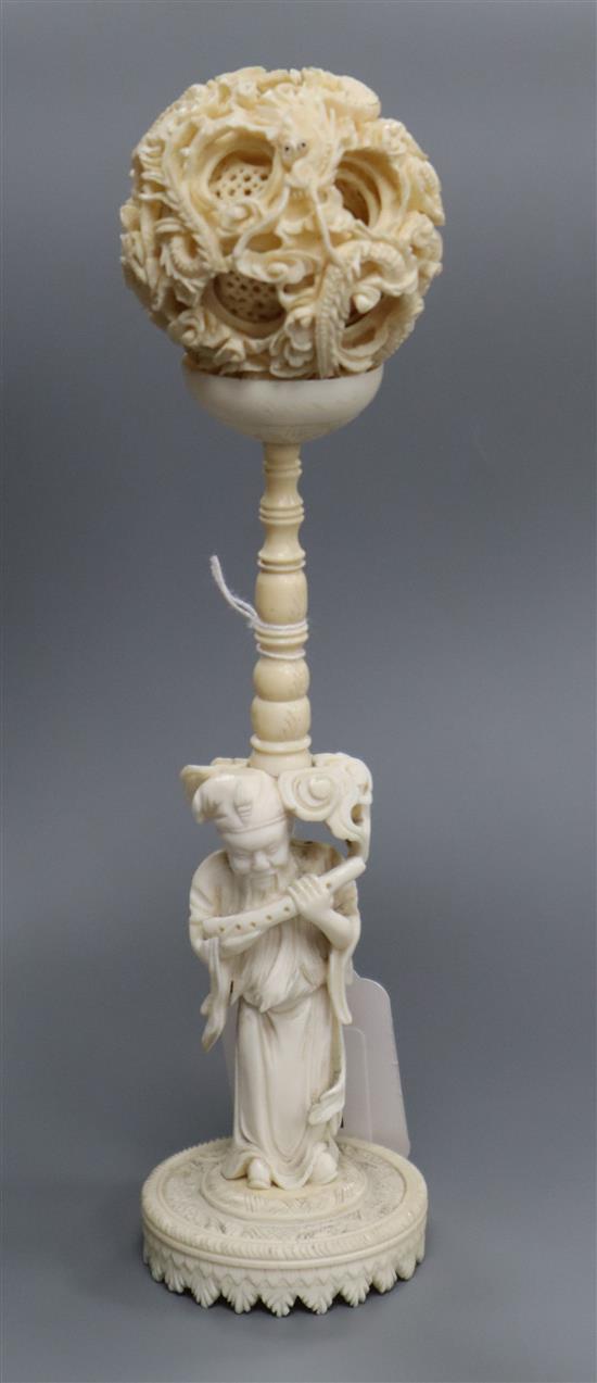 A Chinese ivory puzzle ball with figural stand, early 20th century height 23cm